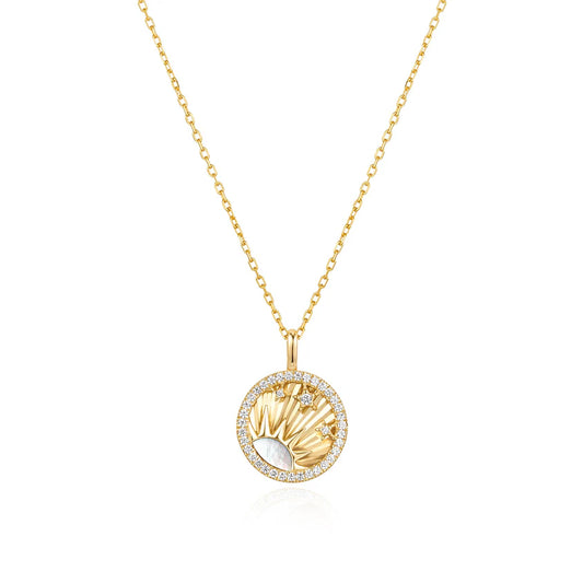Gold necklace with a circular pendant on a white background